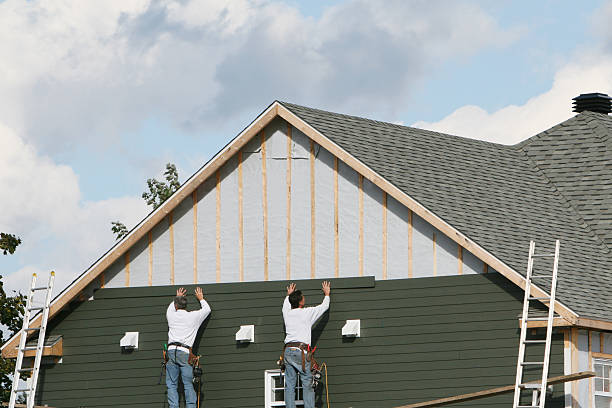 Professional Emergency Siding Repair technician working in Oakland Mills, PA